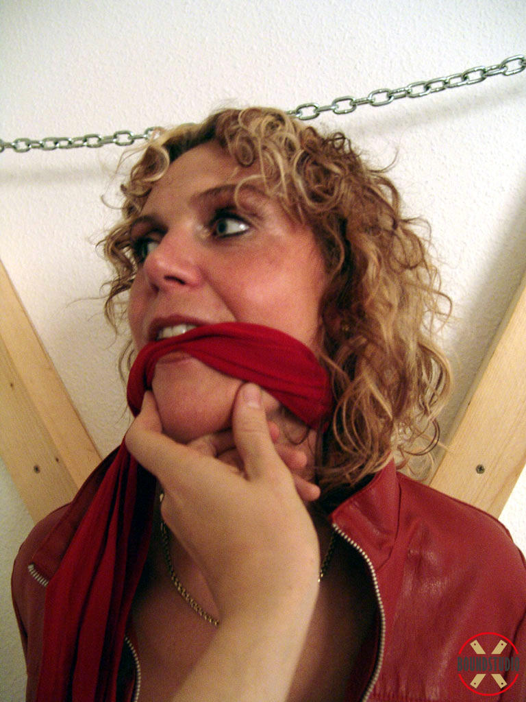 clothed woman blonde lea sports curly hair while being tied up and cleave gagged