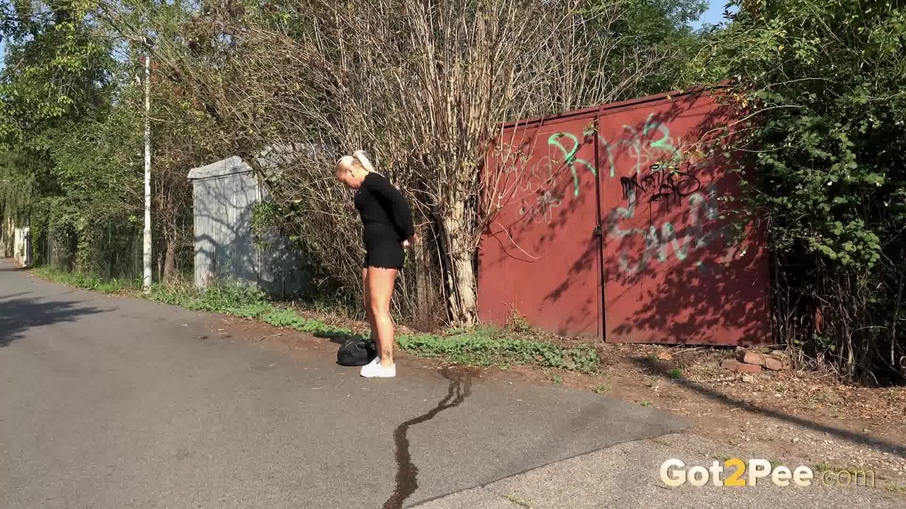 chubby girl naomi squats for a pee alongside a road before carrying on her way