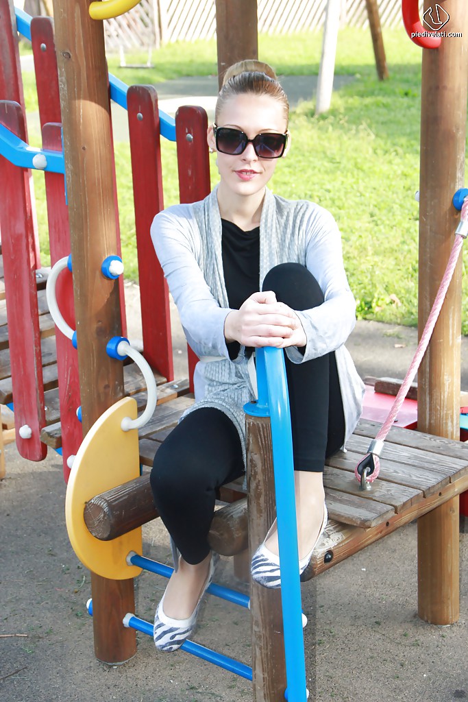 lovely christelle is showing her fine feet on a children playground