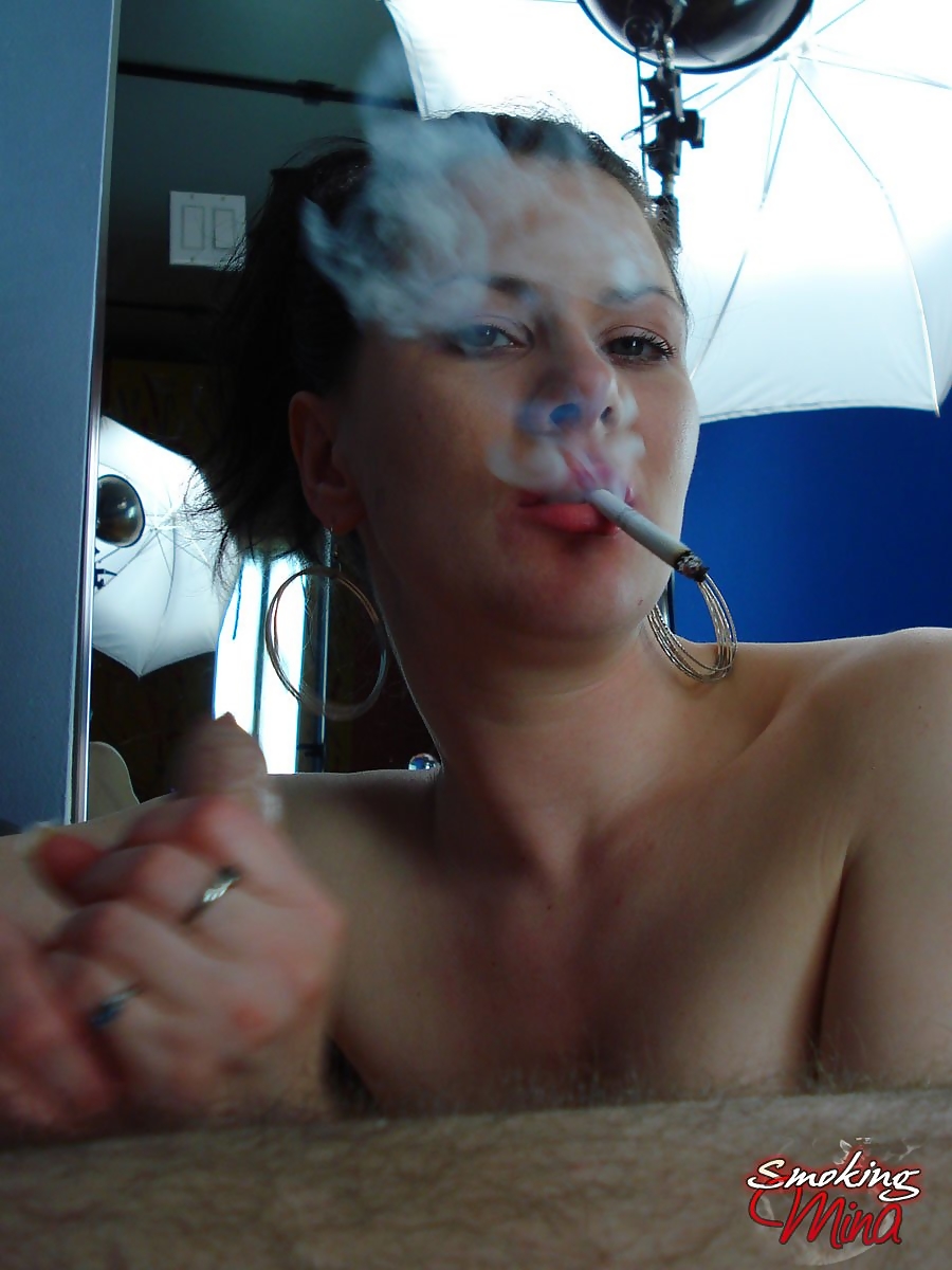brunette chick smokes while licks and sucking on a large cock