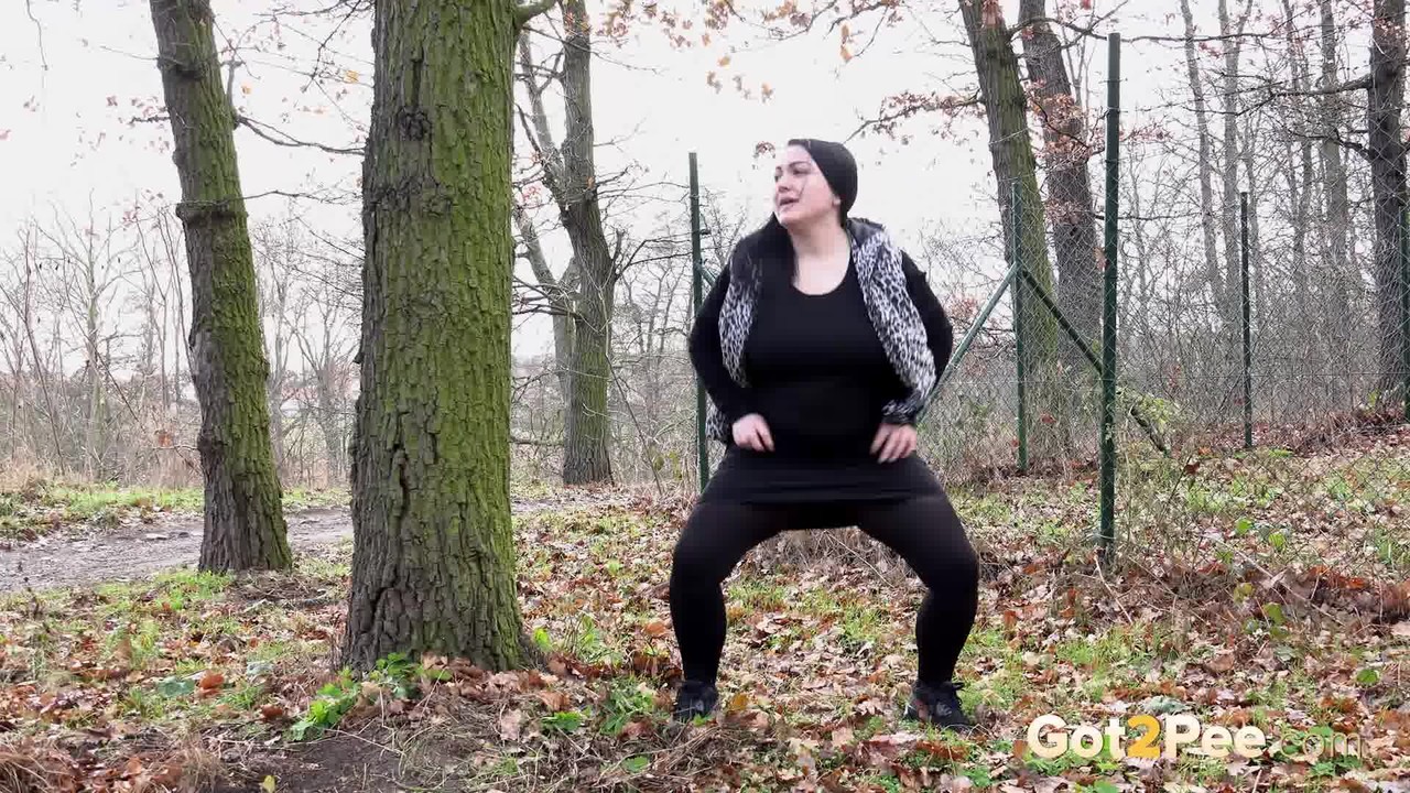 fat chick dora black squats behind a tree to take a piss