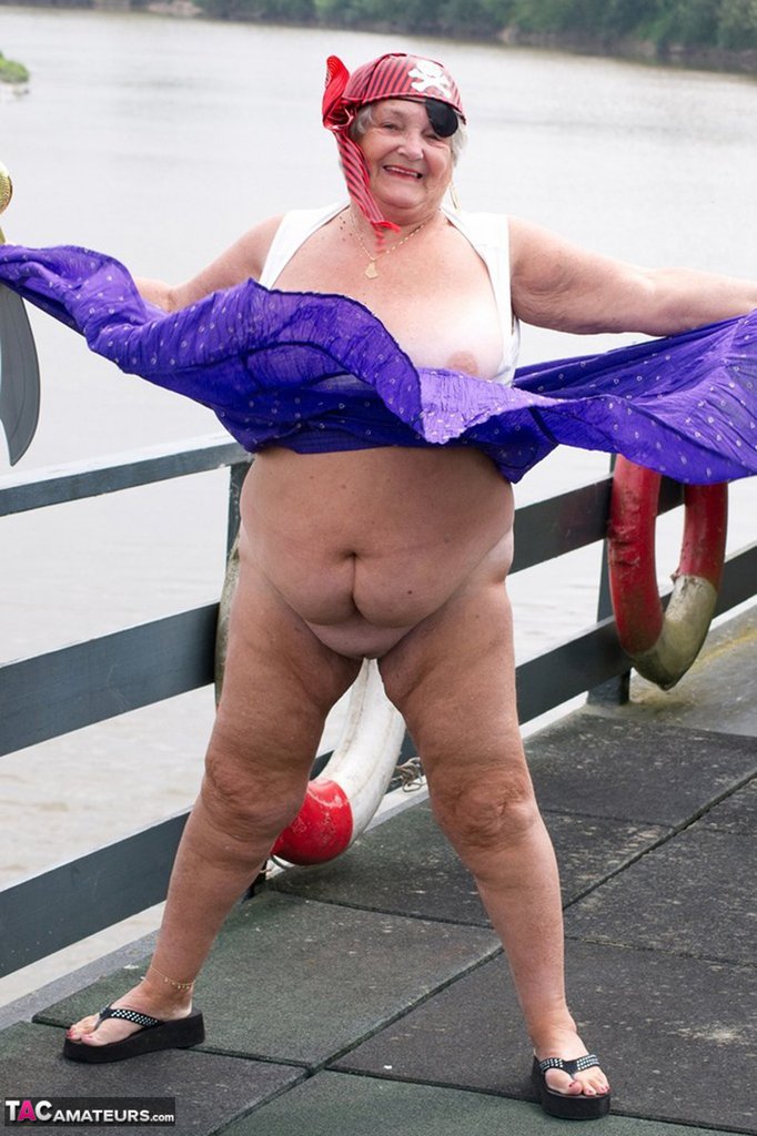 fat british granny exposes herself on a bridge while sporting pirate attire